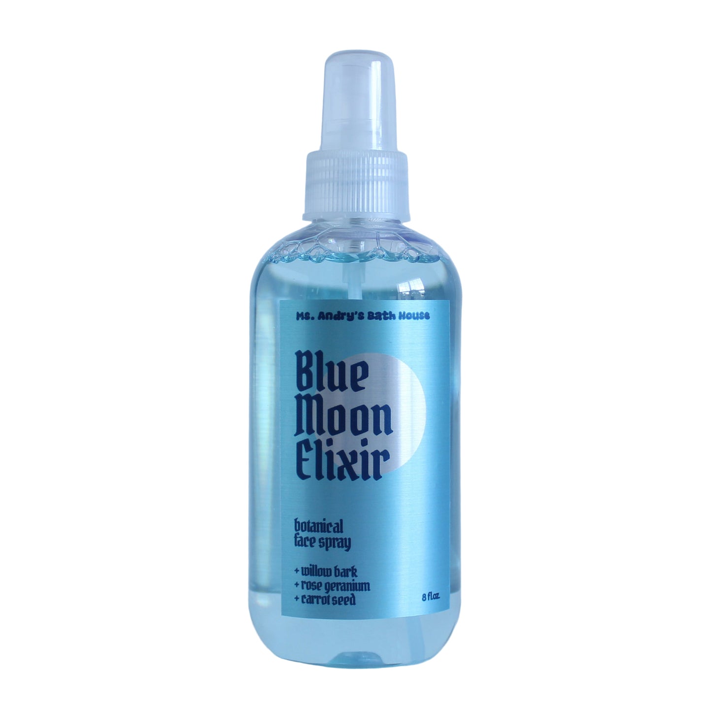 A plastic spray bottle labeled 'Blue Moon Elixir' which is a face toner with natural ingredients like willow bark, rose water, and carrot seed.