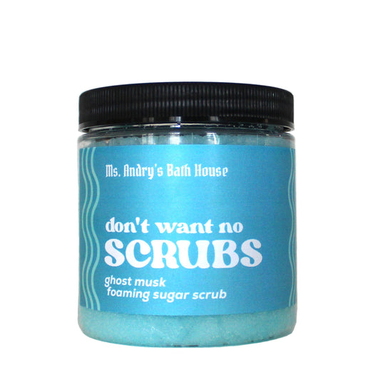 Jar of 'don't want no scrubs' sugar scrub with blue label and black lid on white background