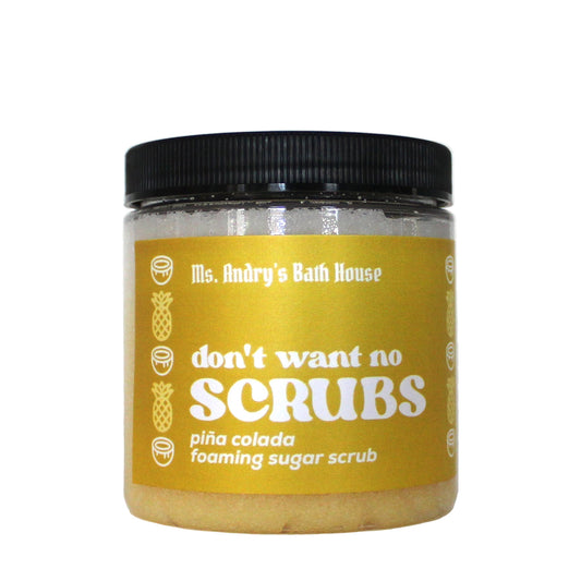 Jar of 'don't want no scrubs' pina colada foaming sugar scrub with a yellow label on a white background