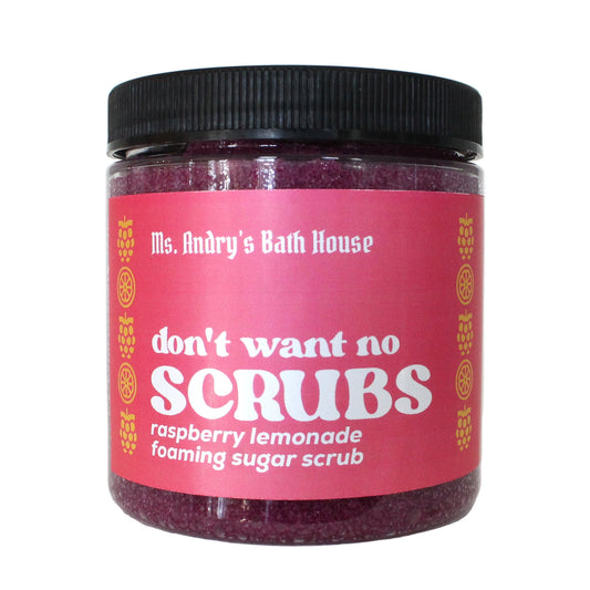 Jar of raspberry lemonade foaming sugar scrub with pink label and black lid on a white background